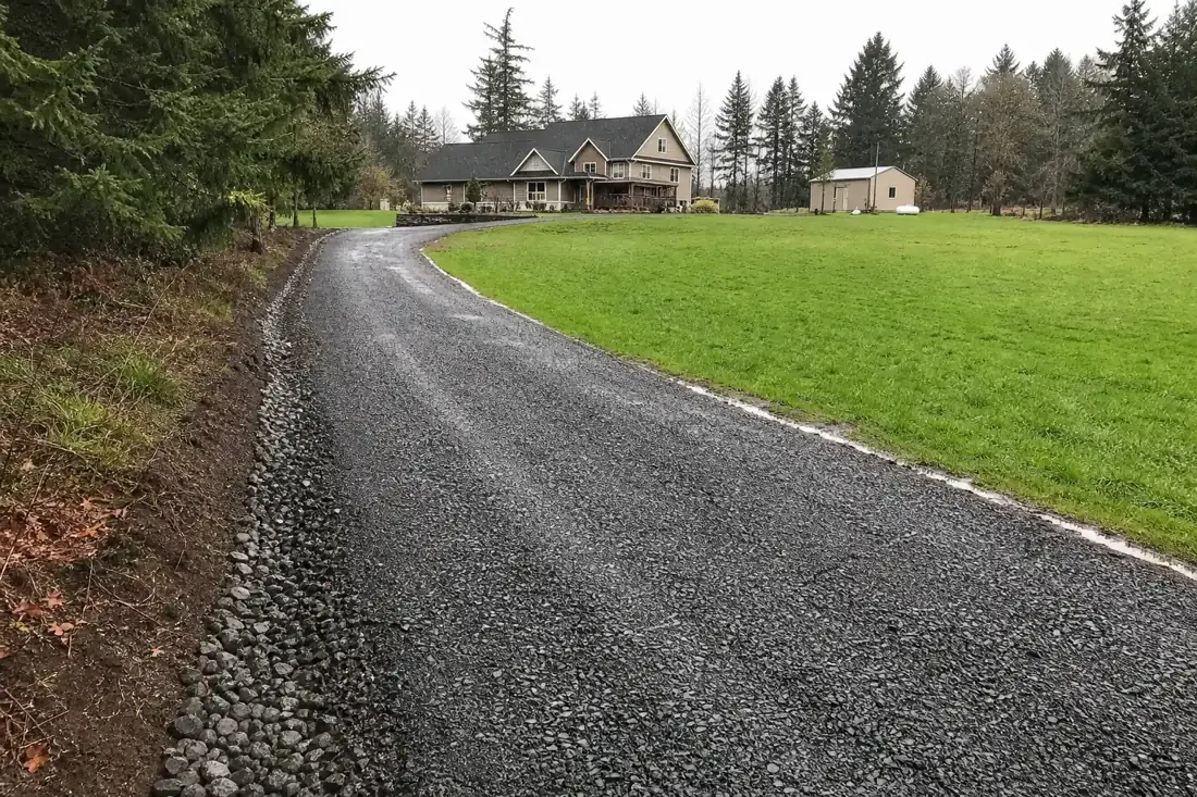 New crushed-rock gravel driveway with drainage on a rural Beaverton, OR property